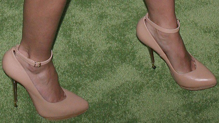 Cameron Diaz elegantly showcases her feet in chic nude ankle-strap heels, a timeless choice that enhances her leg-lengthening silhouette