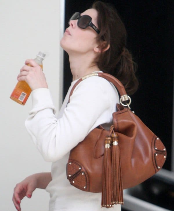 Ashley Greene showcases her timeless style with her beloved fringe Gucci Indy handbag, a testament to her enduring fashion choices