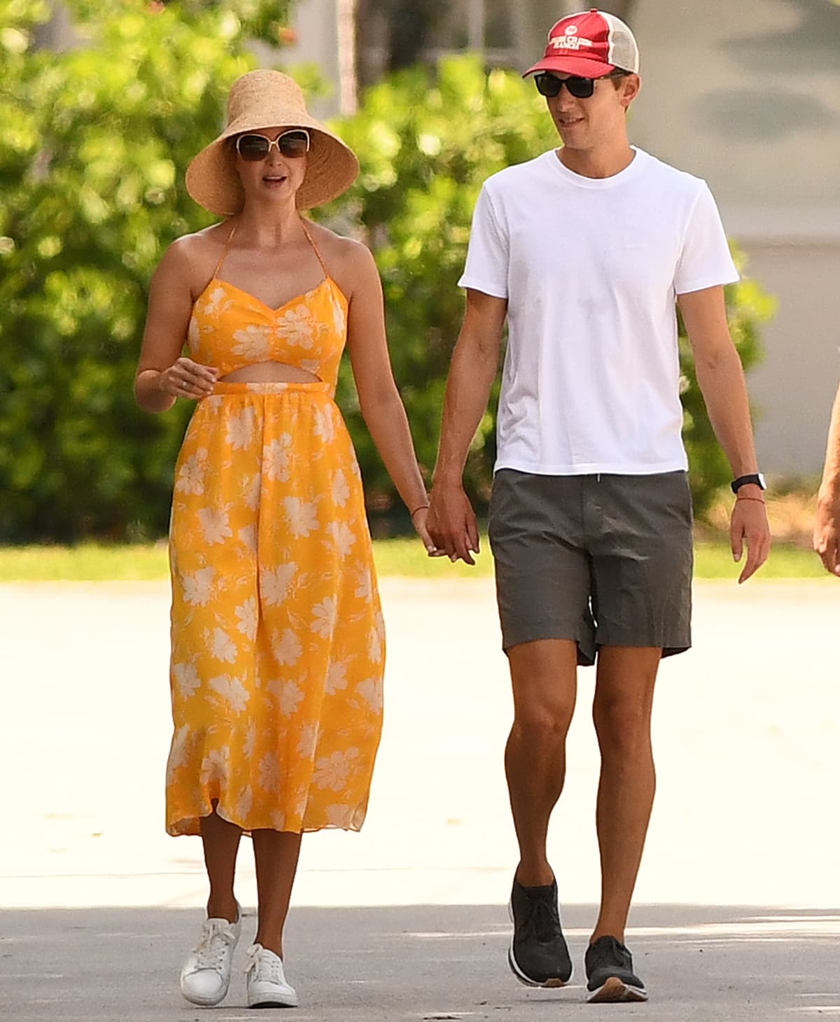 Ivanka Trump wears a yellow cutout sundress as she takes a walk with her husband Jared Kushner