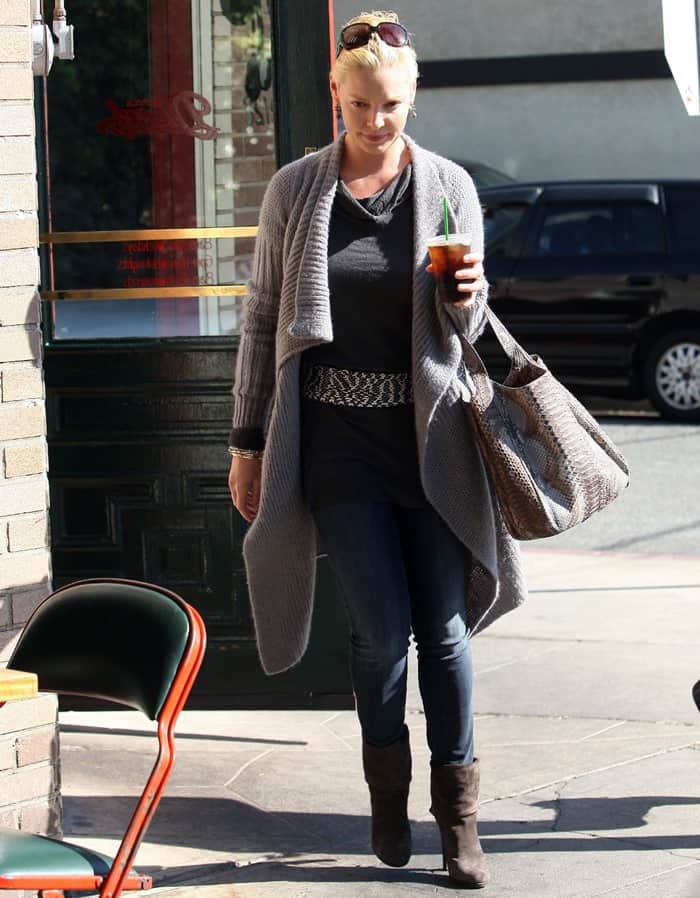 Captured on October 11, 2010, Katherine Heigl exudes autumnal charm as she departs Little Dom's in Los Feliz, effortlessly pairing a chic oversized wrap cardigan with sleek skinny jeans and stylish brown suede ankle boots that add the perfect touch of fall sophistication