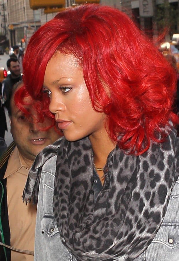 Rihanna in Leopard Printed Scarf by YSL Rihanna turns heads in New York City, perfectly pairing her bold red hair with a leopard-print scarf by YSL
