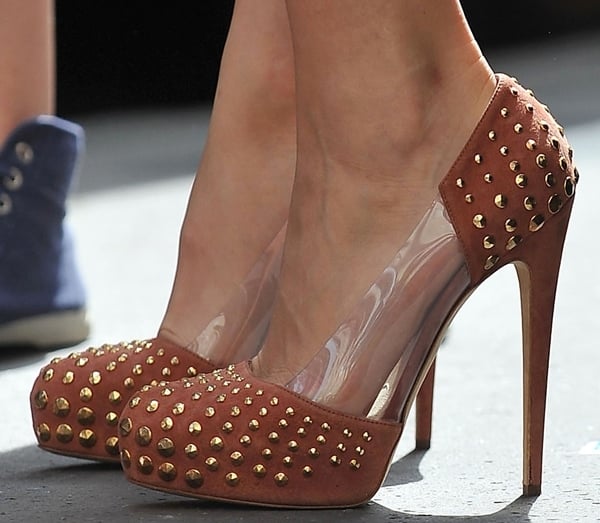 Blake Lively steps out in Brian Atwood “Loca” pumps, featuring rust suede, gold studs, and clear PVC panels that highlight the bold, edgy design