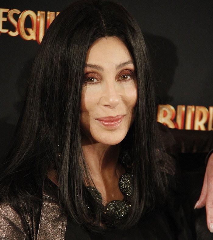Cher wore a metallic jacket layered over a top with a dramatic beaded collar detail