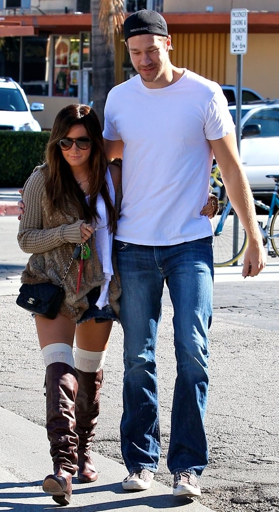 Ashley Tisdale and her boyfriend go to breakfast at Mo's in Toluca Lake Ashley Tisdale exudes cozy chic in a fur-trimmed cardigan, denim shorts, thigh-high socks, and slouchy brown boots, perfectly contrasted by Scott Speer's casual white tee, jeans, and sneakers
