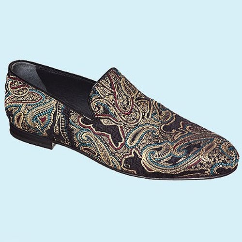 A luxurious Jimmy Choo paisley-embroidered slipper exuding opulence with intricate gold and blue threadwork on a sleek black base