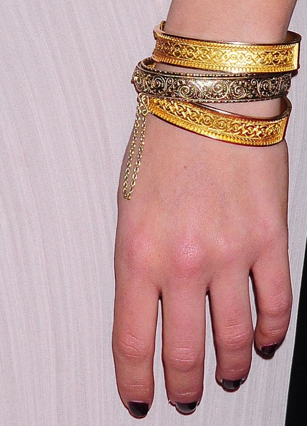 Mila Kunis adds a vintage touch with 19th-century gold bangle bracelets by Fred Leighton, complementing her ethereal Elie Saab gown at the Black Swan New York premiere