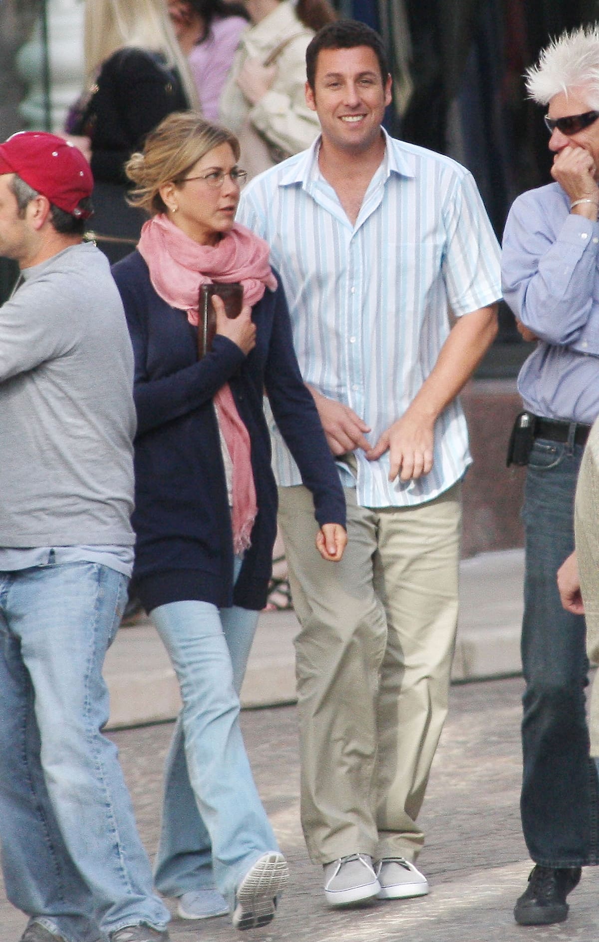 Jennifer Aniston keeps it casual in flared jeans, a long navy cardigan, and flat sneakers while filming Just Go With It with Adam Sandler on Rodeo Drive in Los Angeles on March 22, 2010
