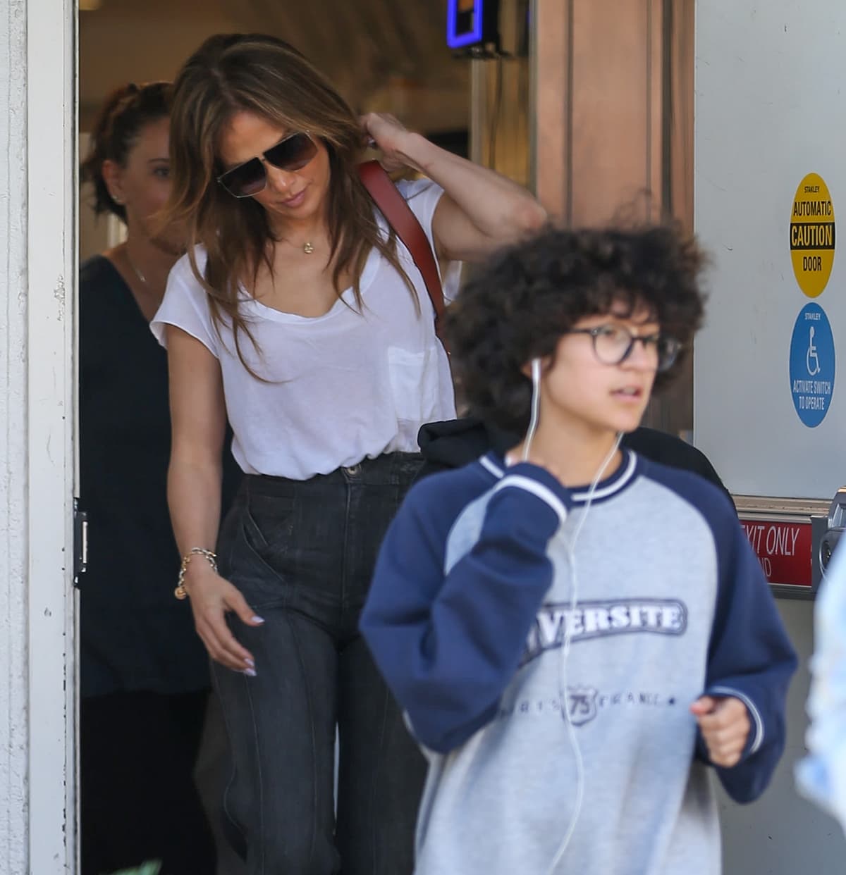 Jennifer Lopez and Emme Maribel Muñiz step out in Los Angeles, with Jennifer keeping it effortlessly chic in a white tee and high-waisted jeans, while Emme opts for a casual sporty sweatshirt