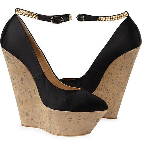 Giuseppe Zanotti La Rocque wedges Giuseppe Zanotti’s “La Rocque” wedges — a sky-high cork platform balanced by a sleek black satin upper and finished with a gold-embellished ankle strap
