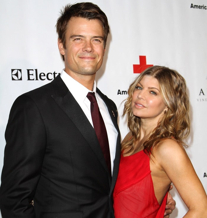 Fergie stuns in a bold red backless dress while posing with Josh Duhamel at the American Red Cross Annual Red Tie Affair