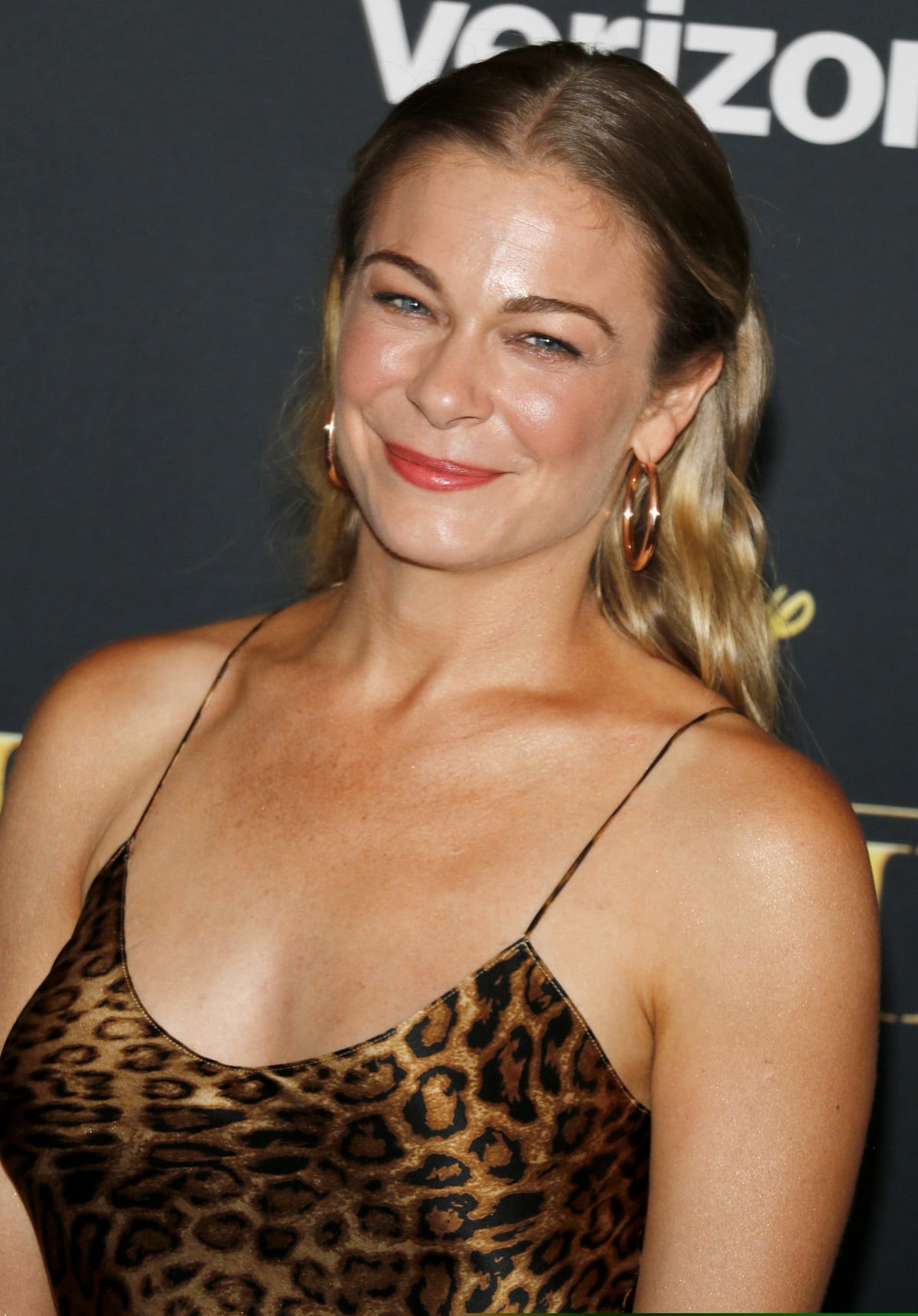 LeAnn Rimes radiates confidence in a sultry leopard-print slip dress paired with bold hoop earrings