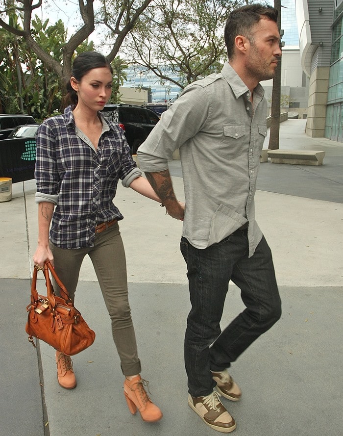 Megan Fox in a "working man"-inspired outfit consisting of a plaid shirt and olive skinny jeans