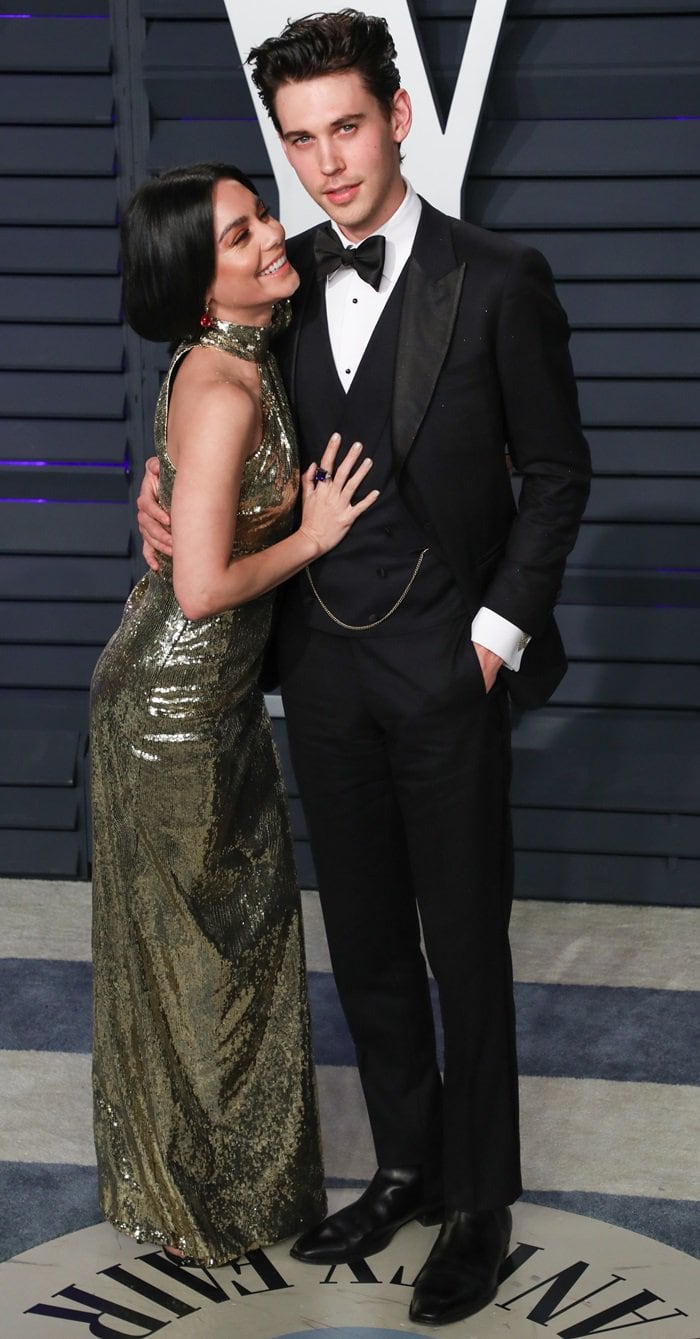 Hudgens and longtime boyfriend Austin Butler radiate old-Hollywood glamour at the 2019 Vanity Fair Oscar Party, where she shimmered in a gold sequined Dundas gown