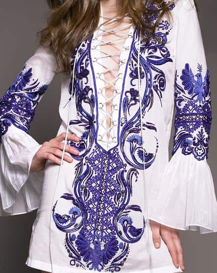 emilio pucci embroidered voile tunic dress Emilio Pucci’s embroidered voile tunic dress features intricate cobalt-blue stitching, a plunging lace-up neckline, and fluted sleeves—capturing the house’s signature jet-set glamour with modern ease