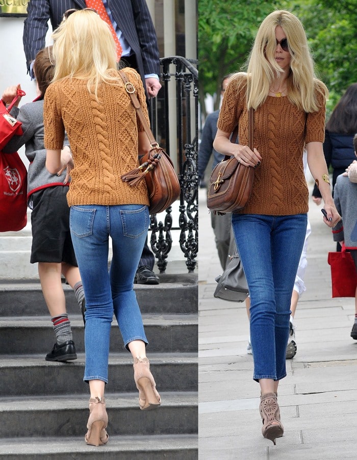 Claudia Schiffer demonstrates how to elevate casual denim with a chunky knit sweater, a classic leather satchel, and statement wedge booties for an effortlessly chic daytime look