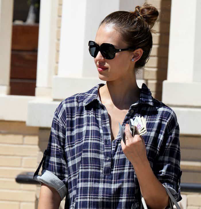 Jessica Alba paired oversized Versace sunglasses with a relaxed plaid tunic, giving her casual maternity look an easy California feel