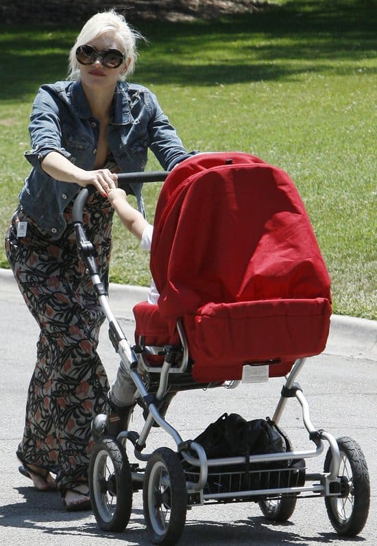 Gwen Stefani strolls through the Huntington Botanical Gardens in San Marino on June 4, 2011, effortlessly chic in a flowy maxi dress, denim jacket, oversized sunglasses, and black flat sandals for a stylish yet comfortable summer look