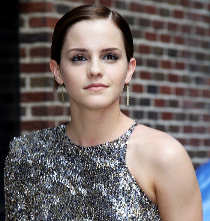 Emma Watson pulls her hair back as she arrives at the Ed Sullivan Theater