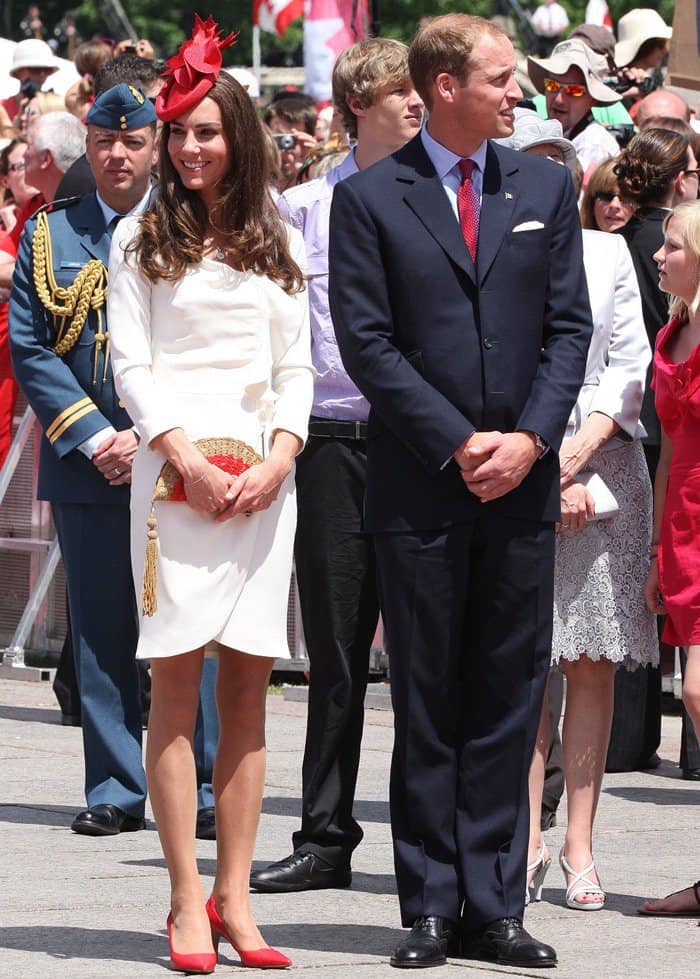 Kate Middleton completed her elegant look at the Canadian Museum of Civilization on July 1, 2011, with cherry red Hobbs Albini square-cut pumps, perfectly complementing her white Reiss Nannette dress, Anya Hindmarch straw fan clutch, and Sylvia Fletcher for Lock Co. maple leaf red hat