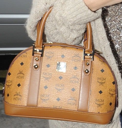 selena gomez mcm bag Selena Gomez proudly displays her stylish MCM bag, a perfect blend of modern fashion and classic design