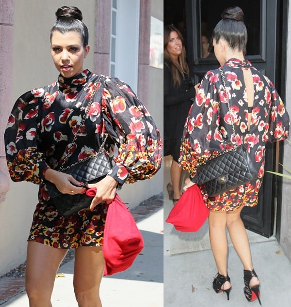 Kourtney Kardashian turned heads in a bold Aryn K Fire Blossom mini dress featuring voluminous sleeves and vivid floral prints, perfectly balanced by her sleek updo, quilted Chanel 2.55 flap bag, and black Christian Louboutin Deva suede fringed heels