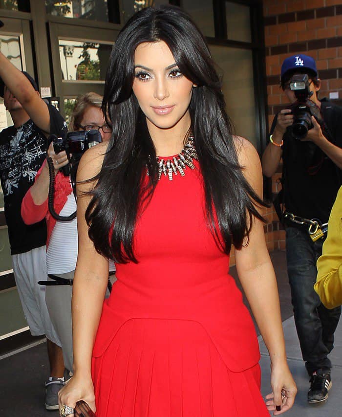 Kim Kardashian captures attention in Manhattan, filming 'Kourtney Kim Take New York' in a stunning red dress, August 30, 2011