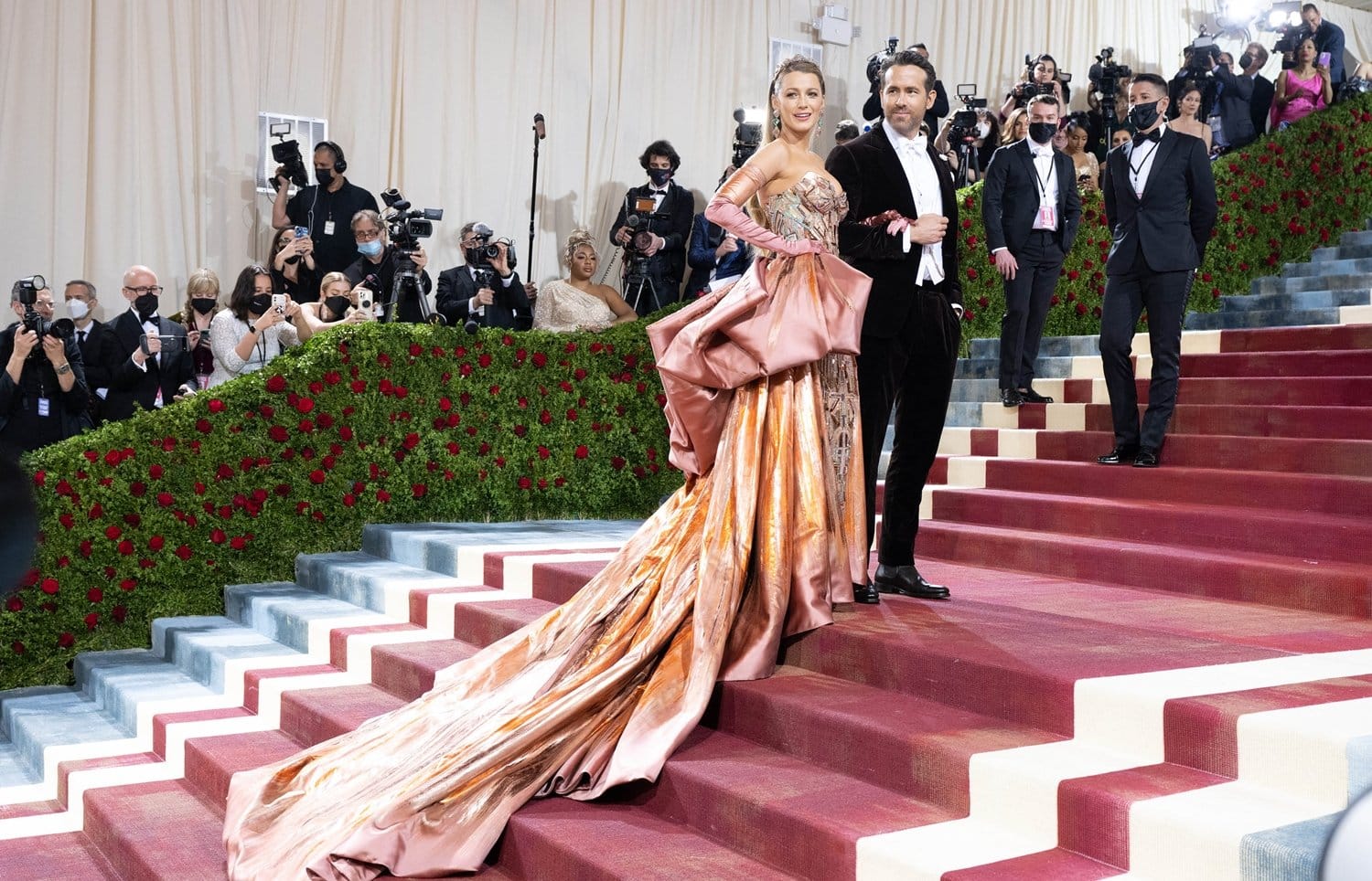 Blake Lively showcases her dramatic color-changing Versace gown alongside Ryan Reynolds in a velvet Ralph Lauren tuxedo as they lead the arrivals at the 2022 Met Gala’s “In America: An Anthology of Fashion” celebration