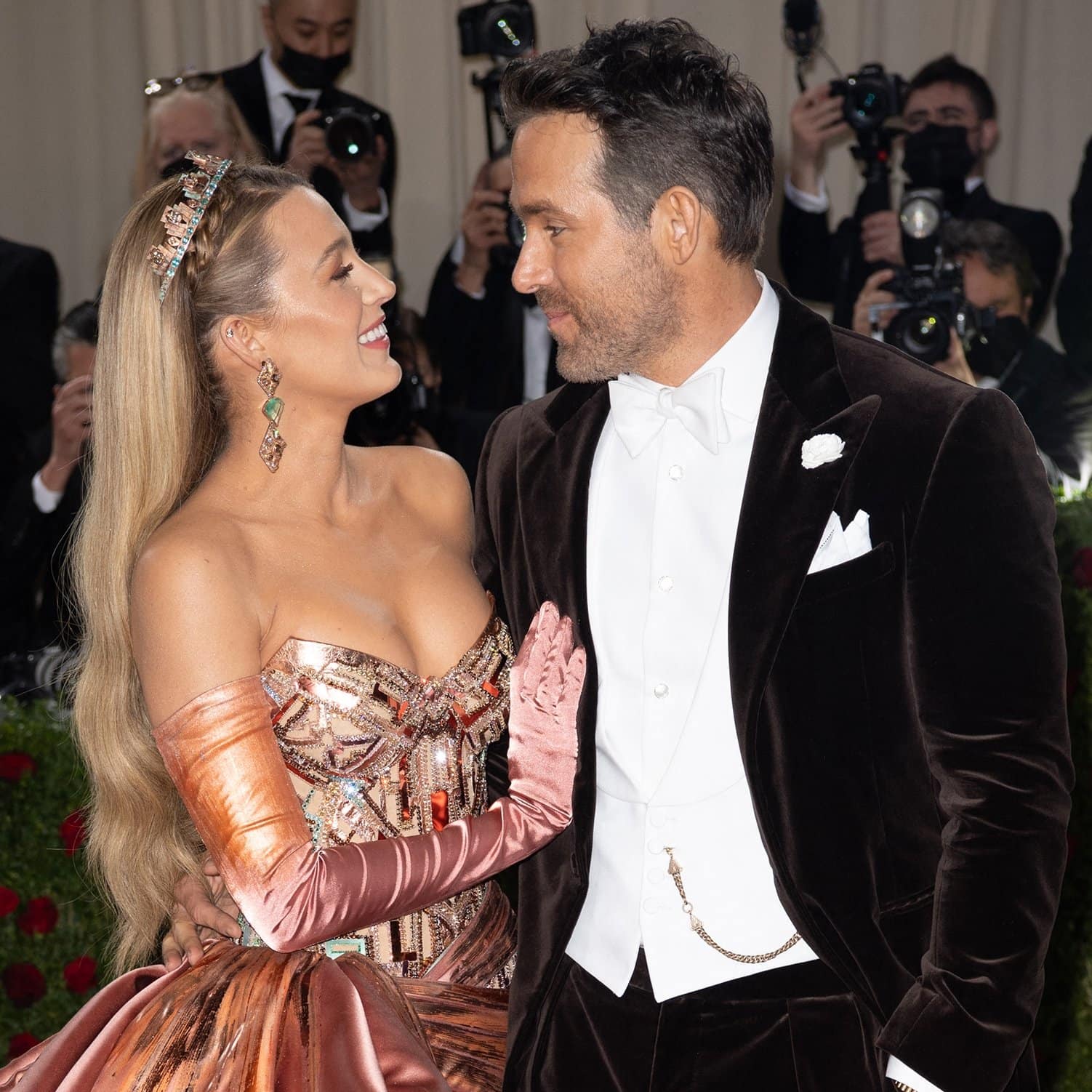 Blake Lively stuns in her transforming copper-to-teal Versace gown inspired by the Statue of Liberty while Ryan Reynolds complements her in a sharp velvet Ralph Lauren tuxedo at the 2022 Met Gala