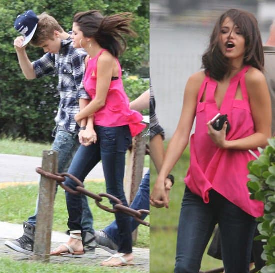 Justin Bieber and Selena Gomez at Lagoa helipoint to take a helicopter over the Corcovado mountain to see the Christ the Redeemer Selena Gomez styled a pink cutout top with dark blue jeans and white sandals