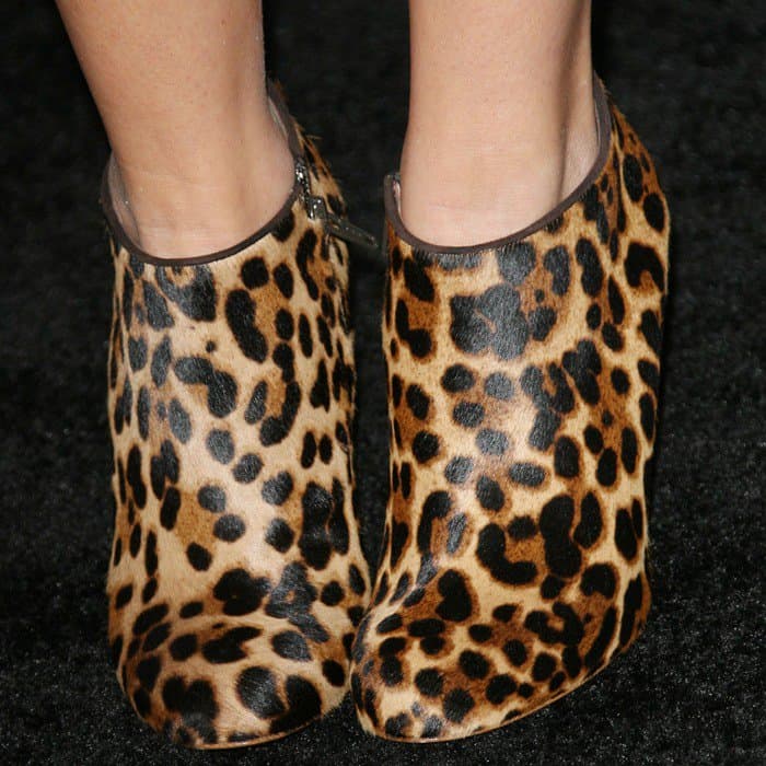 Ashley Tisdale wears Christian Louboutin’s “Morphing” leopard-print booties, letting the sculptural heel and calf-hair texture anchor her otherwise soft, lace-forward red-carpet look
