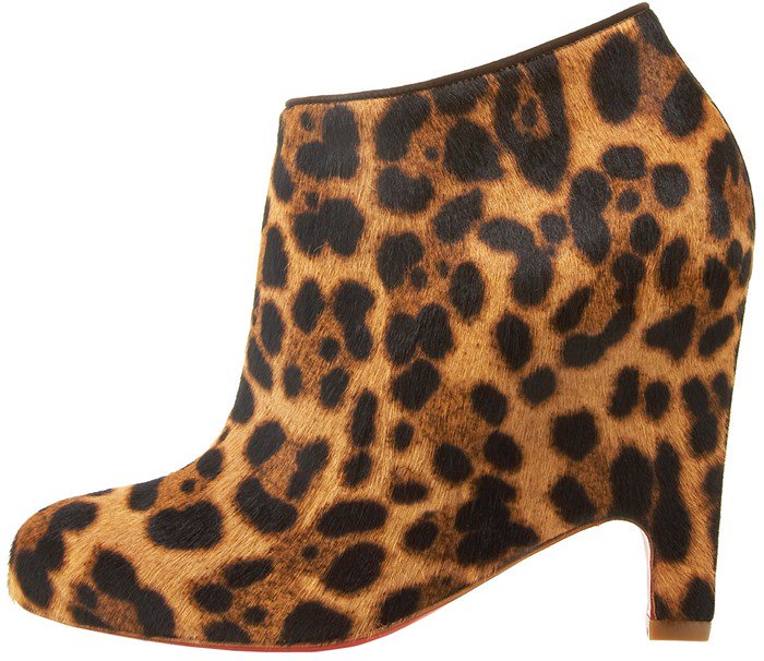 Christian Louboutin “Morphing” leopard-print booties, crafted from dyed calf hair with an architectural, sculpted heel that adds edge and structure to otherwise delicate looks