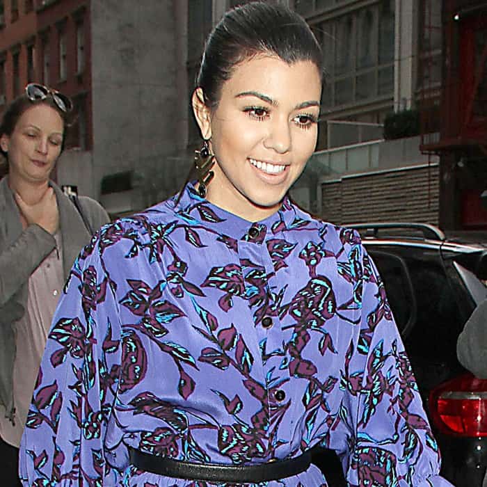 Kourtney Kardashian steps out in New York City wearing a vibrant purple floral Sunner dress cinched at the waist with a black belt