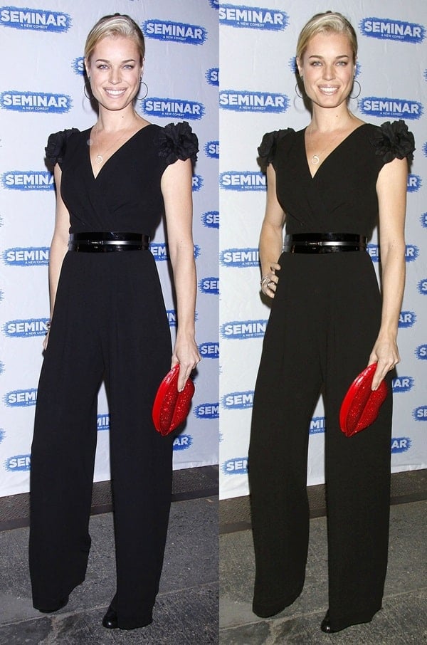 Chic and Unique: Rebecca Romijn stuns in a sleek black jumpsuit, cinched with a glossy belt and paired with black patent pumps, while her sparkling red lip-shaped, crystal-encrusted clutch adds the perfect pop of playful glamour