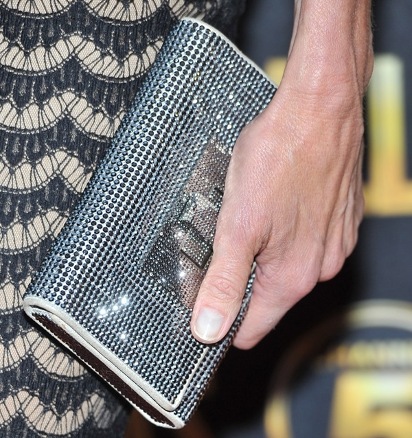 Brenda Strong displaying her sparkling Swarovski clutch, adding a touch of glamour to her elegant ensemble