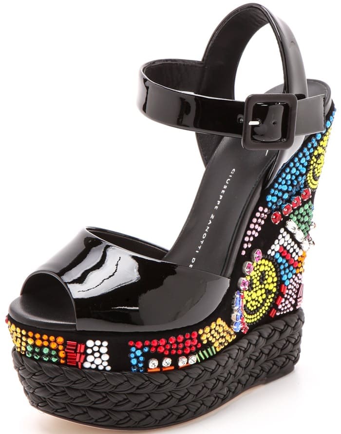 Colorful Swarovski crystals create a shimmering, '90s-inspired design across the steep platform and wedge heel of these patent leather Giuseppe Zanotti sandals.