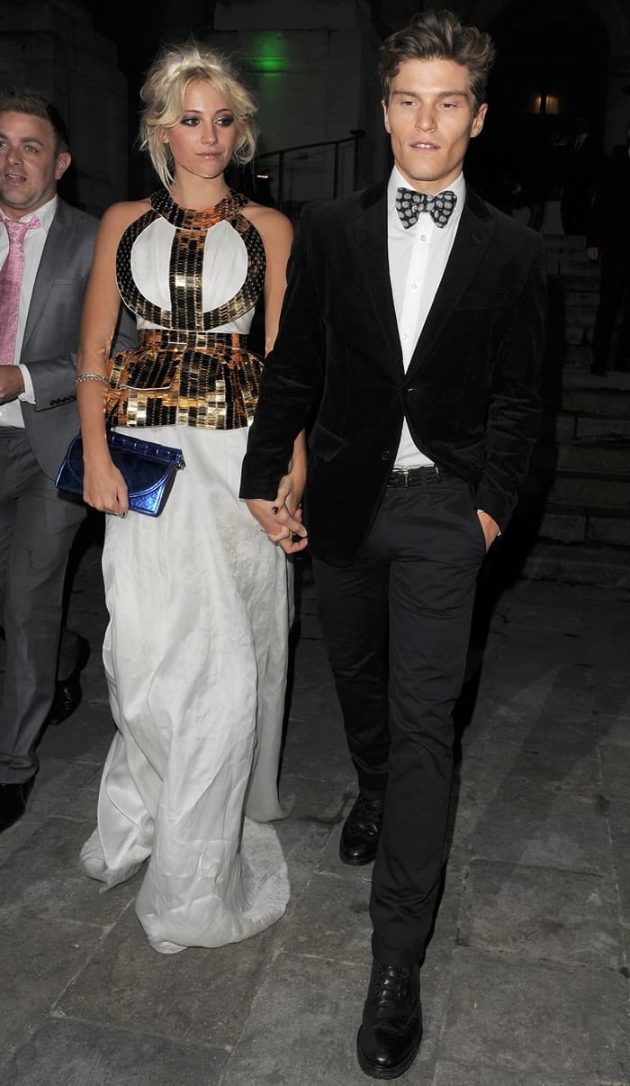 Pixie Lott holds on to boyfriend Oliver Cheshire's hand as she leaves her 21st birthday party
