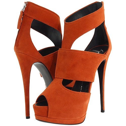 Giuseppe Zanotti’s bold orange suede peep-toe platforms, featuring wide crossover straps and a sky-high stiletto heel