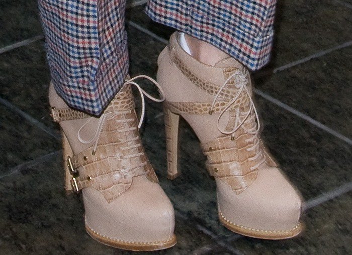 The archival Dior Guetre ankle boots showcase their layered gaiter construction from the front, featuring concealed platforms, slim lace-up panels, and gold buckle hardware