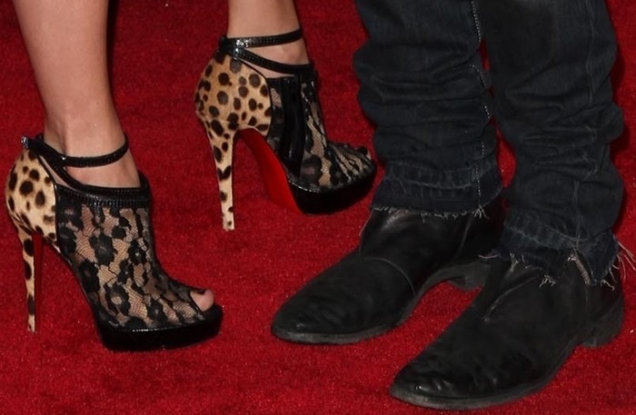 Jennifer Lopez showcases her bold style in leopard-and-lace Christian Louboutin ankle booties, featuring peep toes, a glossy platform, and the brand’s signature red soles — a striking mix of wild elegance and sultry sophistication