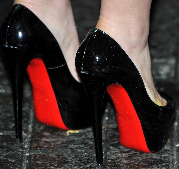 Lily Collins finished her Versace Resort 2012 cocktail dress with glossy black patent Christian Louboutin "Very Prive" peep-toe pumps featuring concealed platforms, soaring stiletto heels, and the house's signature red lacquered soles