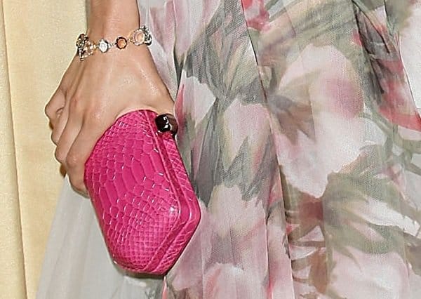 Nina Dobrev adds a pop of color with a textured fuchsia Rebecca Minkoff 'Fling' clutch, perfectly complemented by a delicate multi-stone bracelet for a touch of sparkle
