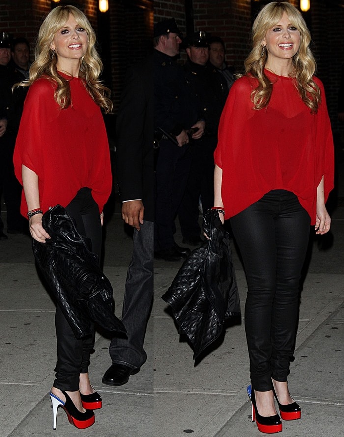 Sarah Michelle Gellar in a see-through red sweater styled with a pair of wet look jeans