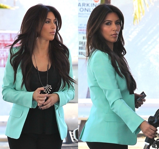 Kim Kardashian stopping for gas Kim Kardashian in loose black tank top and black skinny jeans topped off by a mint green blazer