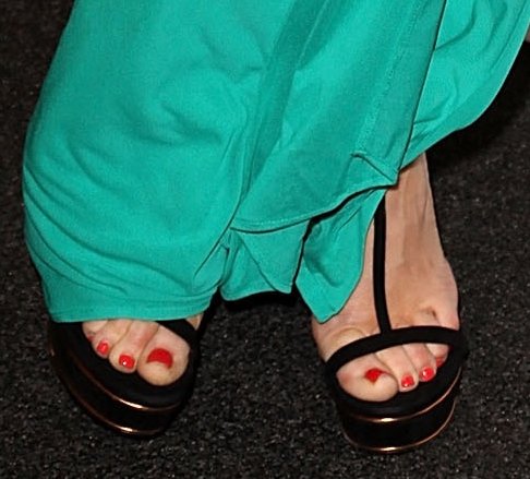 Rose McGowan shows off her red pedicure in black Gucci sandals, adding a chic contrast to her teal gown at the MOCA Gala