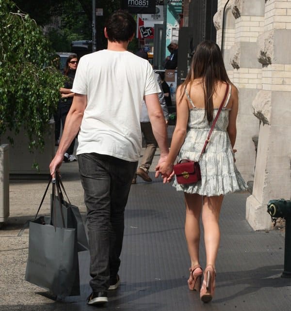 Lea Michele and boyfriend Cory Monteith holding hands while shopping in Manhattan on May 16, 2012 — even in platform heels, Lea appeared noticeably shorter than Cory, highlighting their striking height difference