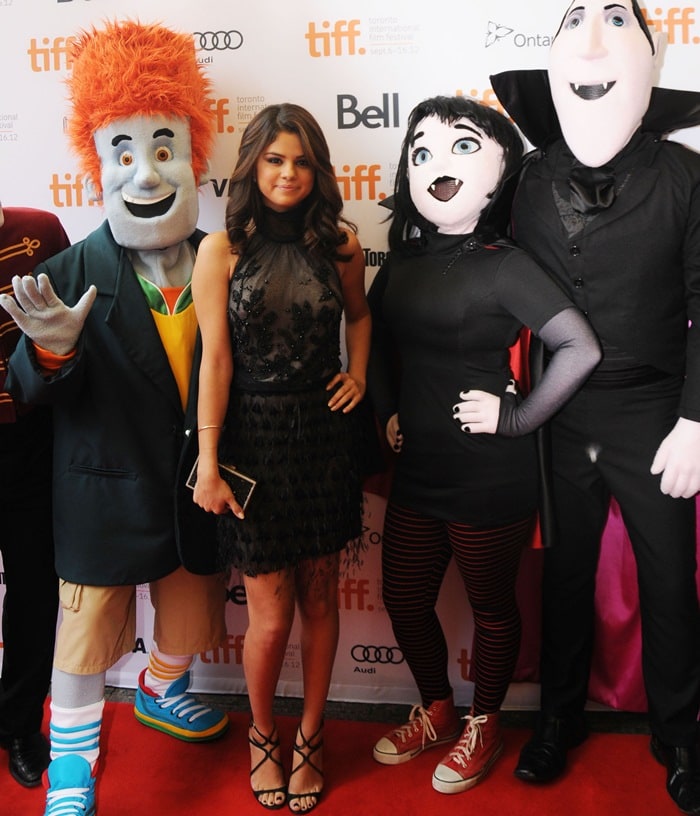 Selena Gomez attends the Toronto International Film Festival wearing a black embellished mini dress styled with strappy Jimmy Choo “Lance” sandals, adding polish to the playful premiere moment