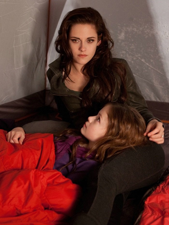 Kristen Stewart, as vampire Bella Swan, wears a custom Belstaff double-breasted leather blazer while sharing a quiet moment with Renesmee in Breaking Dawn – Part 2
