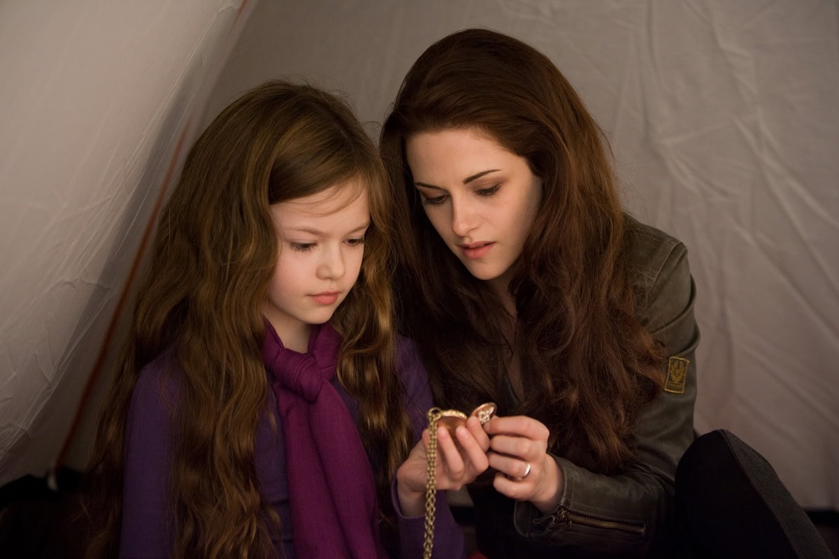 Kristen Stewart as Bella Swan shares a heartfelt moment with Mackenzie Foy as Renesmee, wearing the custom Belstaff leather blazer—complete with the brand’s signature logo patch on the sleeve