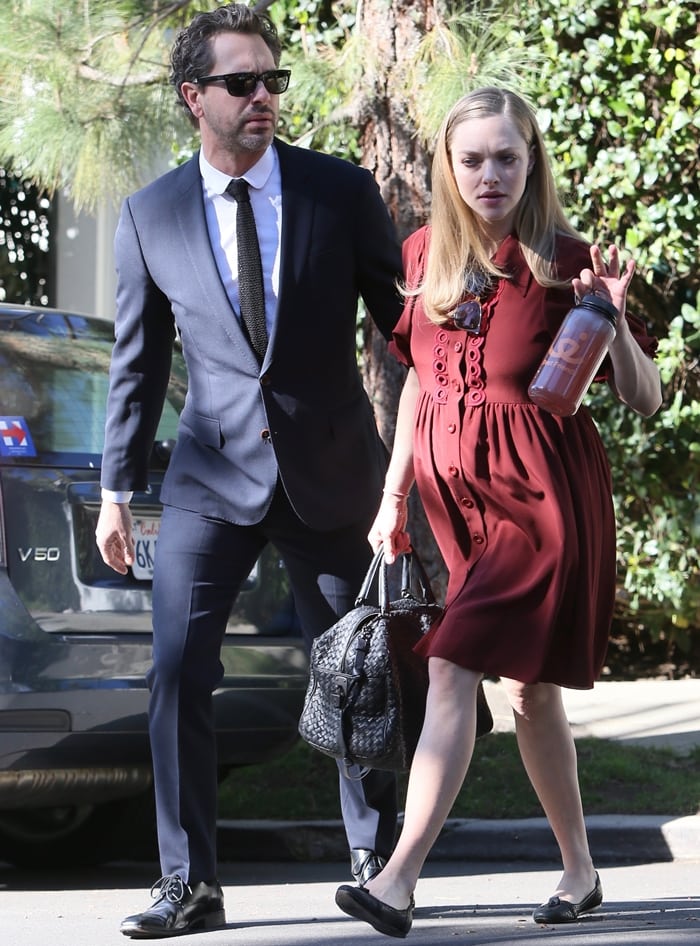 Pregnant Amanda Seyfried opted for comfort-forward style in a burgundy maternity dress paired with classic black ballet flats as she stepped out with fiancé Thomas Sadoski in Los Angeles on March 3, 2017