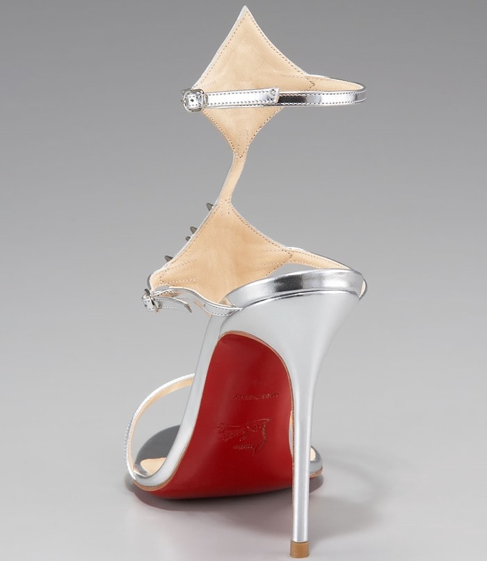The towering stiletto heel and signature red sole highlight the sculptural silhouette of Christian Louboutin’s archival “Lady Max Spike” sandals